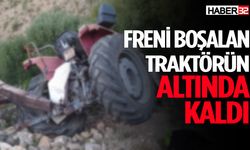 Freni boşalan traktörün altında kaldı